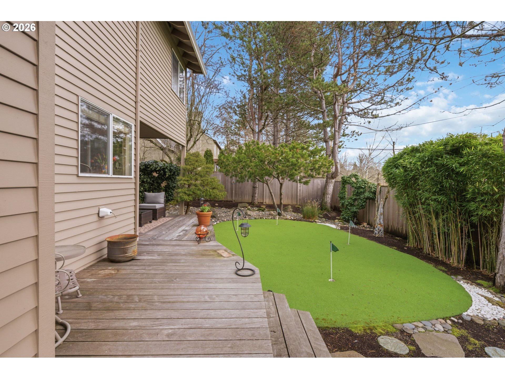6108 Southwest Kruse Ridge Drive Portland, OR 97219 - Photo 39 of 42 a view of a backyard with plants and a patio