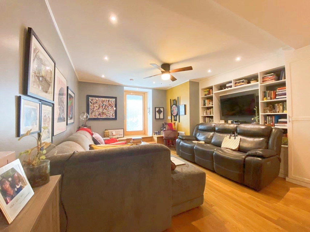 240 Heath Street, Unit 103 Boston, MA 02130 - Photo 6 of 10 a living room with furniture window and a flat screen tv