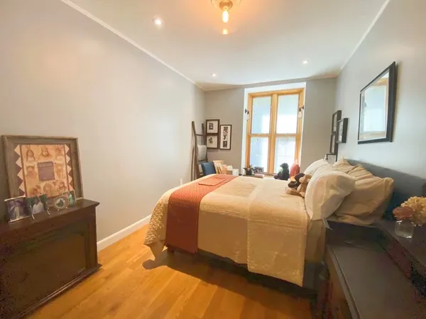 a bed sitting in a bedroom next to a window