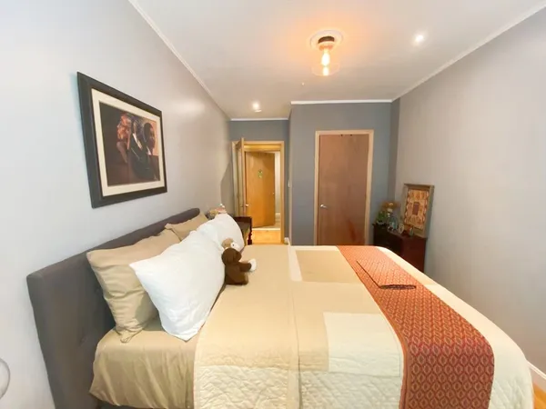 a bedroom with a bed and wooden floor