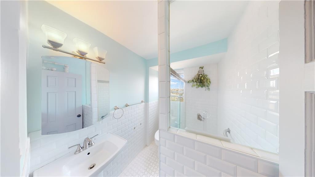 191 73rd Street, Unit 296 Brooklyn, NY 11209 - Photo 11 of 20 a bathroom with a bathtub and shower