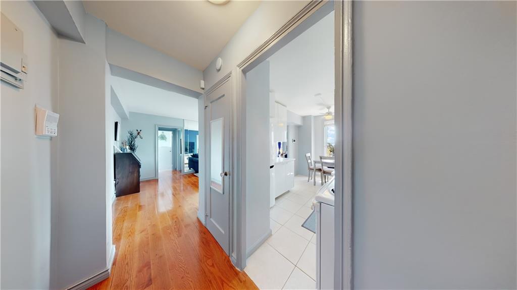 191 73rd Street, Unit 296 Brooklyn, NY 11209 - Photo 4 of 20 a view of a hallway with wooden floor and living room