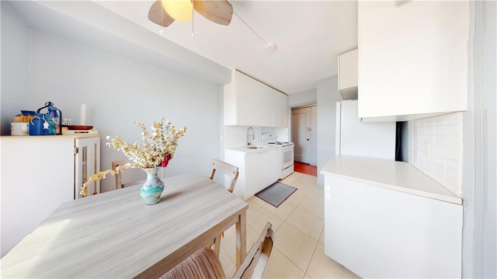 191 73rd Street, Unit 296 Brooklyn, NY 11209 - Photo 6 of 20 a dining room with furniture and a chandelier