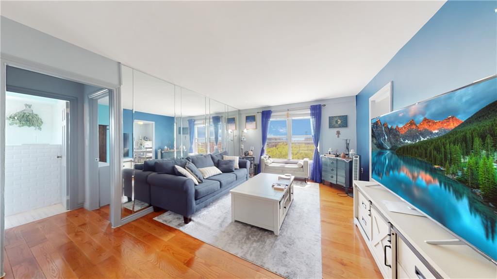 191 73rd Street, Unit 296 Brooklyn, NY 11209 - Photo 7 of 20 a living room with furniture and a flat screen tv