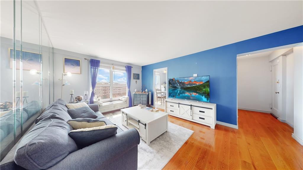 191 73rd Street, Unit 296 Brooklyn, NY 11209 - Photo 8 of 20 a living room with furniture and a flat screen tv