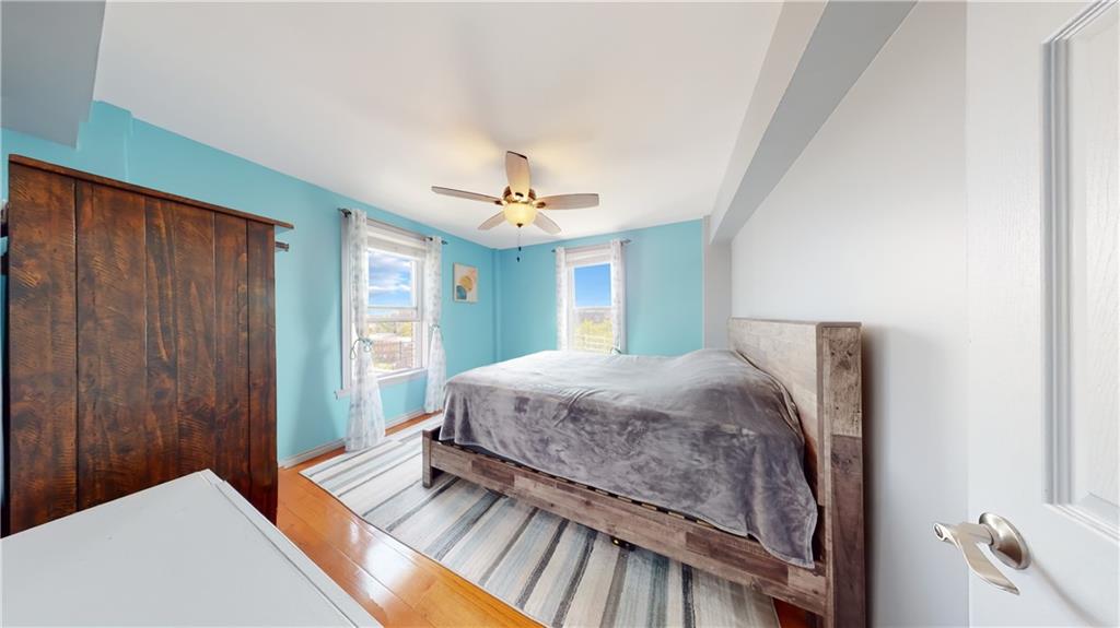 191 73rd Street, Unit 296 Brooklyn, NY 11209 - Photo 9 of 20 a bedroom with a bed and a chandelier