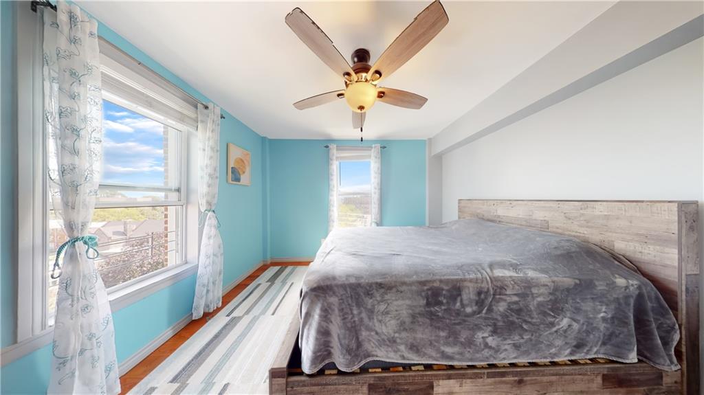 191 73rd Street, Unit 296 Brooklyn, NY 11209 - Photo 10 of 20 a bed sitting in a bedroom next to a window