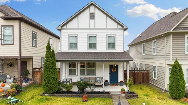 a front view of a house with yard and furniture