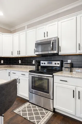 a view of a hallway with workspace and wooden floor