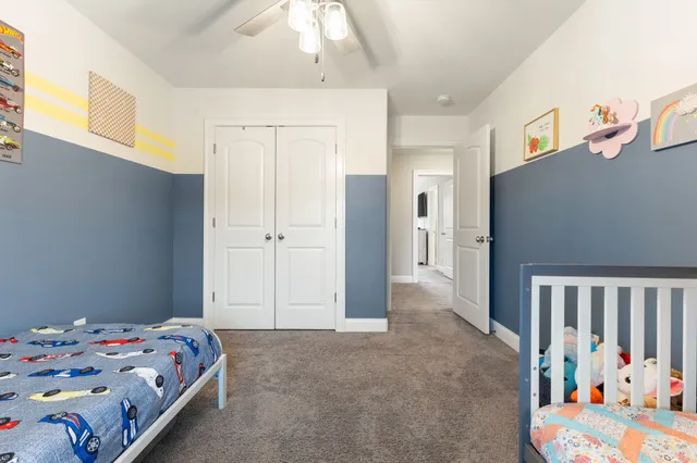 a bedroom with a bed and a desk