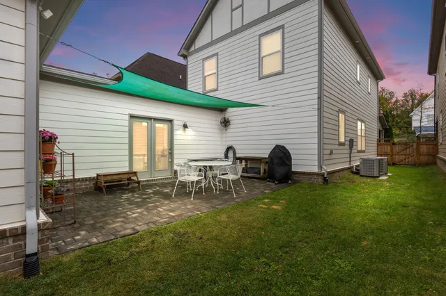 a view of a patio with table and chairs a barbeque with wooden fence