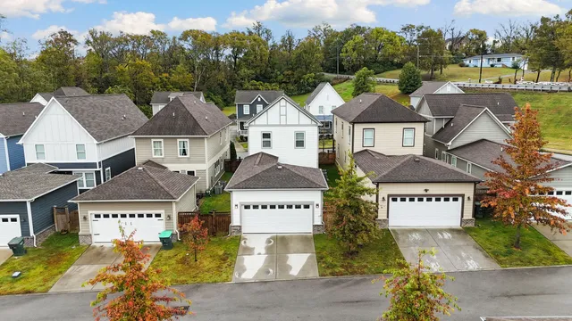 an aerial view of a house with a swimming pool and lake view