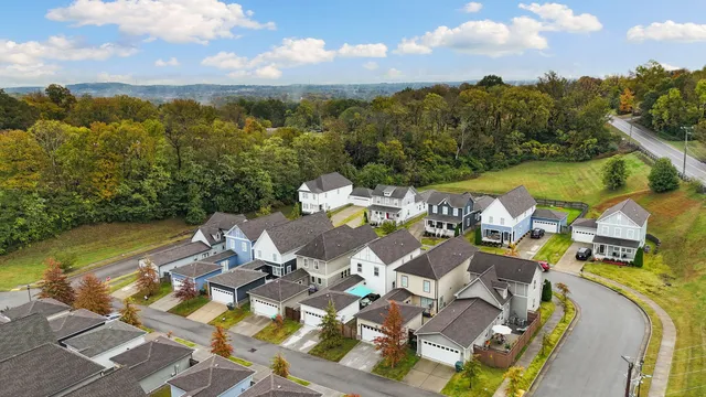 an aerial view of residential houses with outdoor space and swimming pool