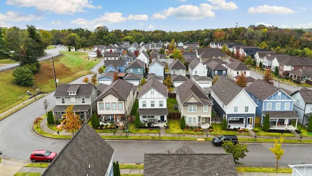 an aerial view of residential houses with outdoor space and river