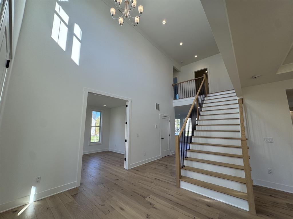 12 Old County Road, Unit 20 Hudson, MA 01749 - Photo 17 of 30 wooden floor in an empty room with a mirror