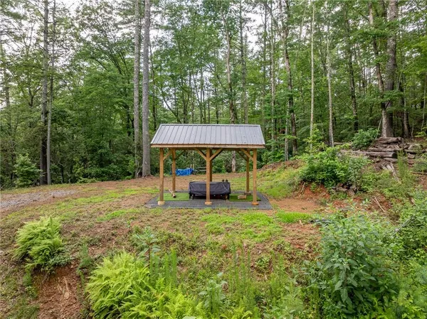 a view of a patio with a table and chairs under an umbrella