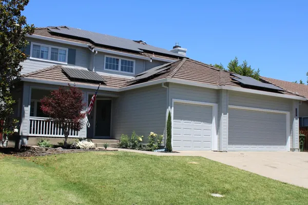 a front view of a house with a garden