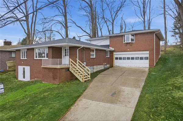 a view of a house with a yard and a garage