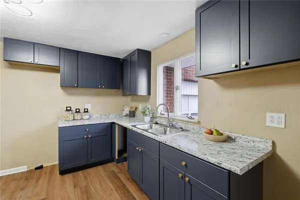 a kitchen with a sink a stove and cabinets