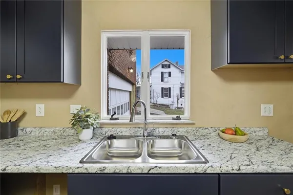 a kitchen with a sink and a stove top oven