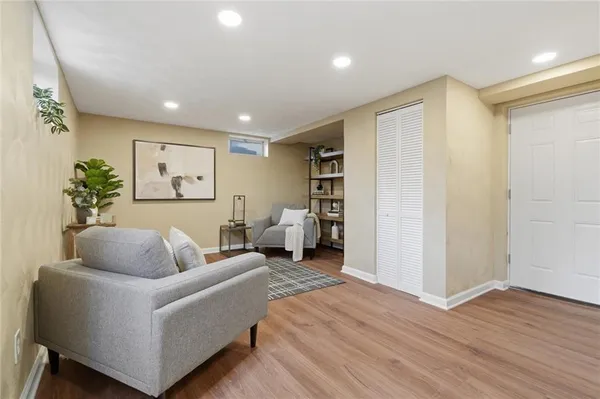 a living room with furniture and a wooden floor