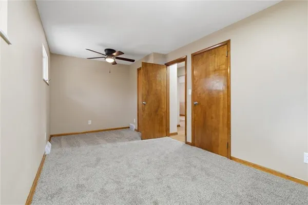 a view of a room with a ceiling fan