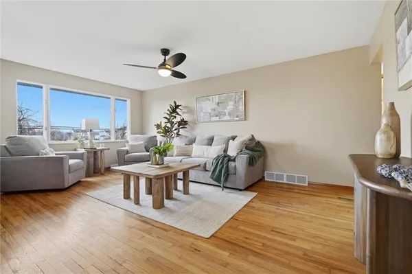 a living room with furniture a rug and a flat screen tv