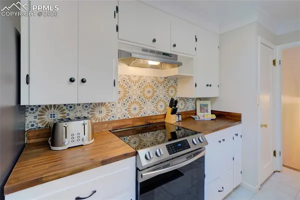 a kitchen with a sink stove and cabinets