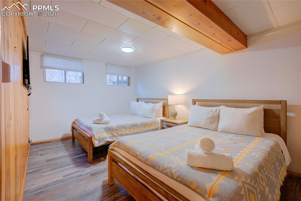 5835 Carnia Road Cascade, CO 80809 - Photo 26 of 31 a bedroom with two beds and wooden floor