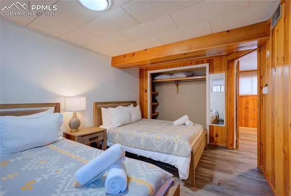 a bedroom with a bed and wooden floor