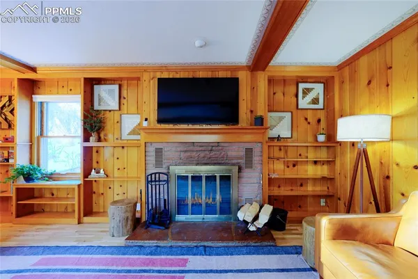 a living room with furniture a fireplace and a flat screen tv
