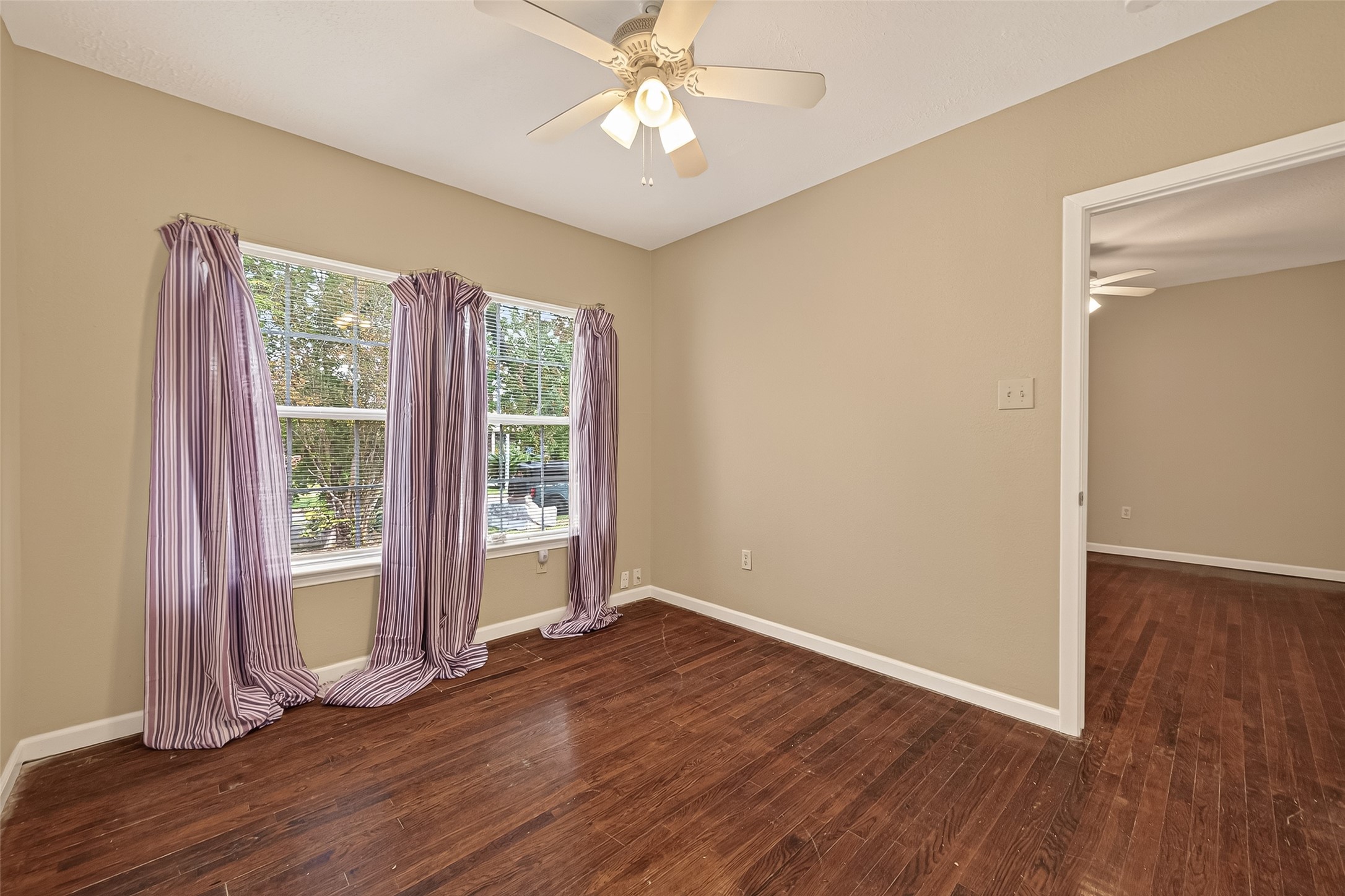 1402 Munger Street Houston, TX 77023 - Photo 11 of 22 a view of an empty room with wooden floor and a window