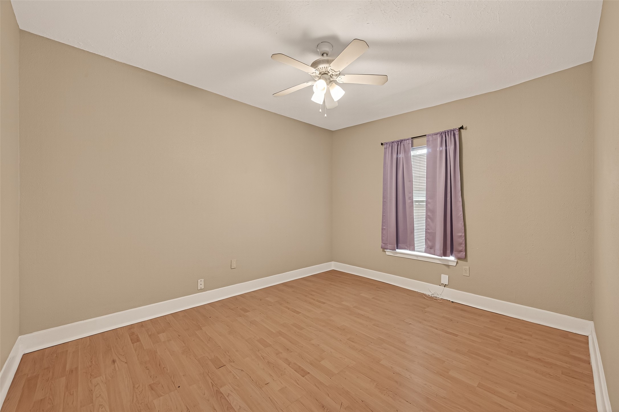 1402 Munger Street Houston, TX 77023 - Photo 14 of 22 wooden floor in an empty room with a window
