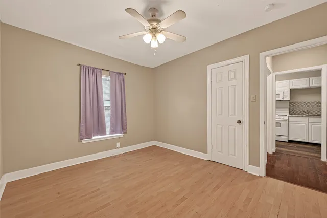 wooden floor in an empty room with a window