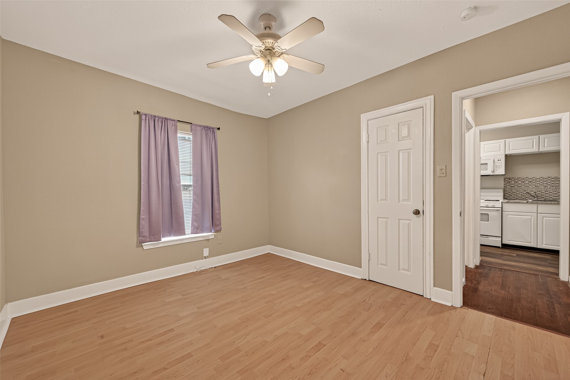 1402 Munger Street Houston, TX 77023 - Photo 15 of 22 wooden floor in an empty room with a window