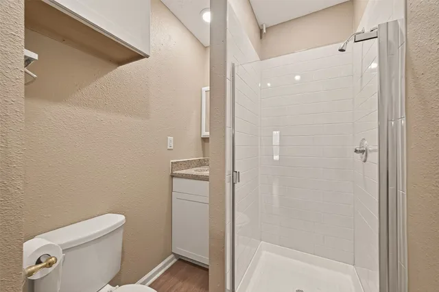 a bathroom with a shower a toilet and sink