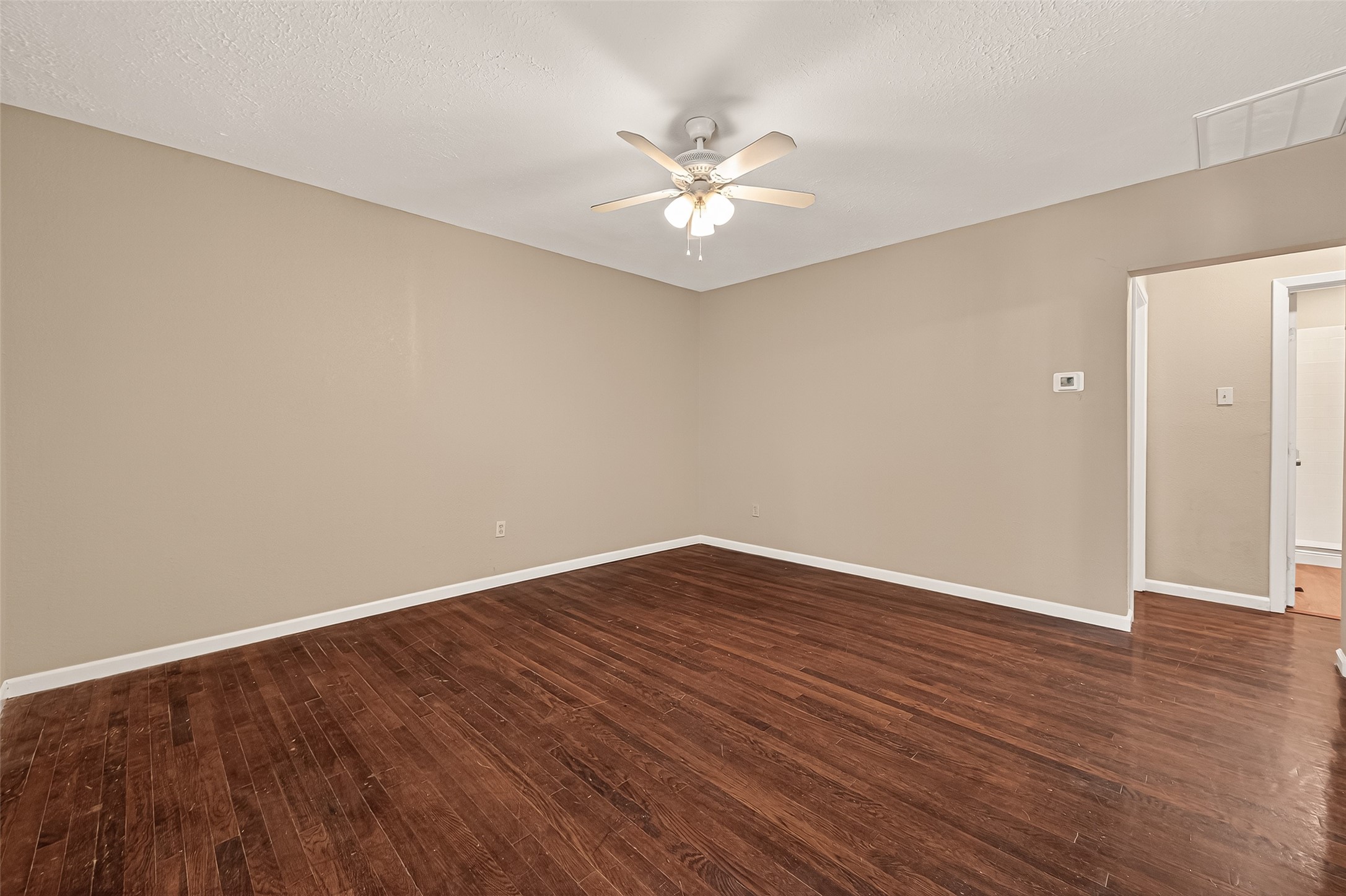 1402 Munger Street Houston, TX 77023 - Photo 5 of 22 a view of an empty room with wooden floor