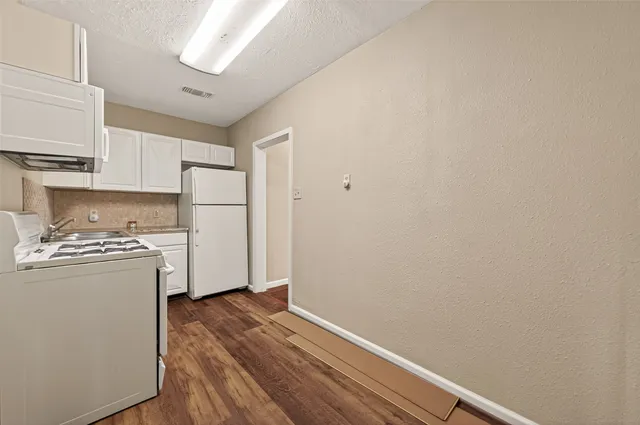 a view of a kitchen with refrigerator and stove
