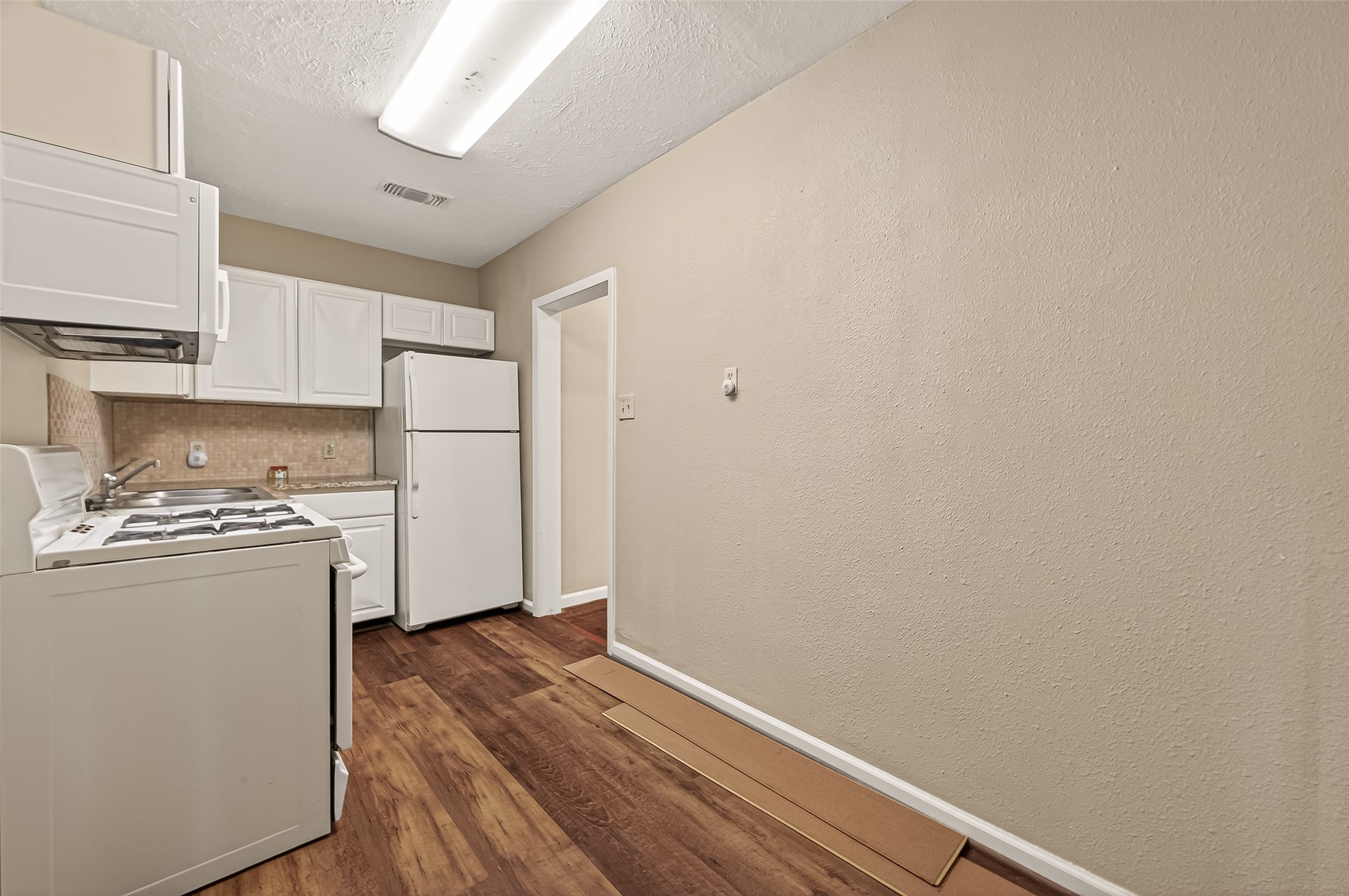 1402 Munger Street Houston, TX 77023 - Photo 8 of 22 a view of a kitchen with refrigerator and stove
