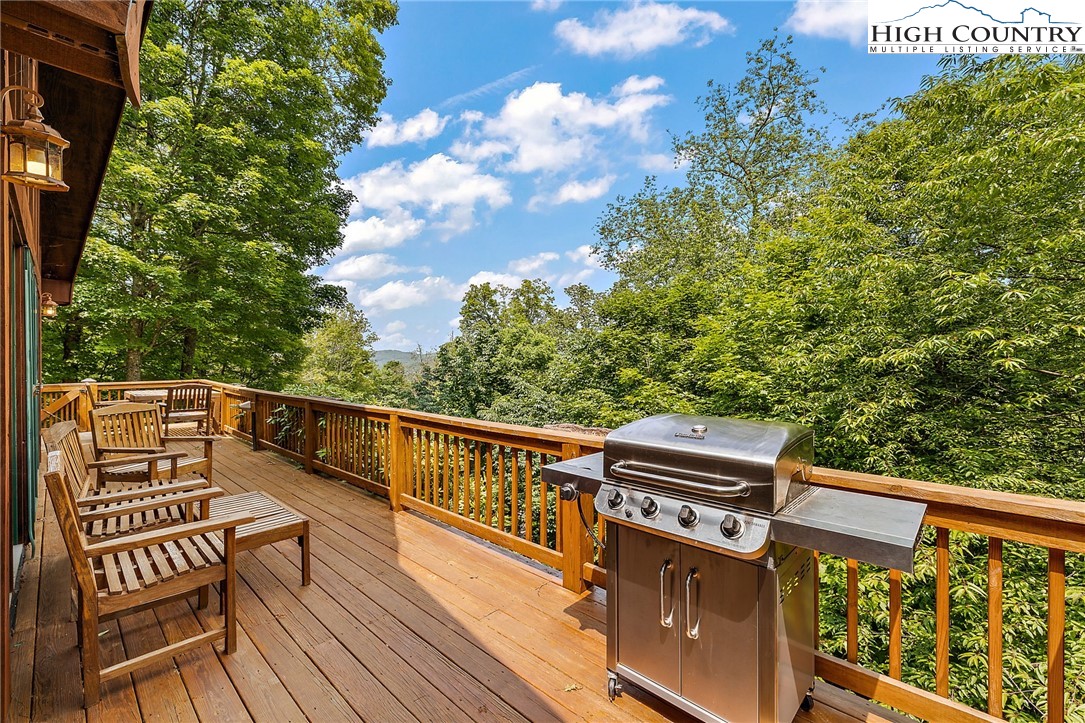 320 Timber Ridge Road Sugar Mountain, NC 28604 - Photo 12 of 30 a view of a balcony with wooden floor and fence