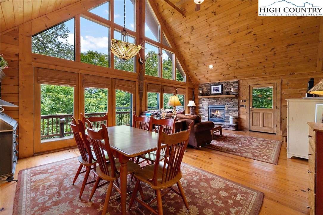320 Timber Ridge Road Sugar Mountain, NC 28604 - Photo 15 of 30 a dining room with furniture a fireplace and wooden floor