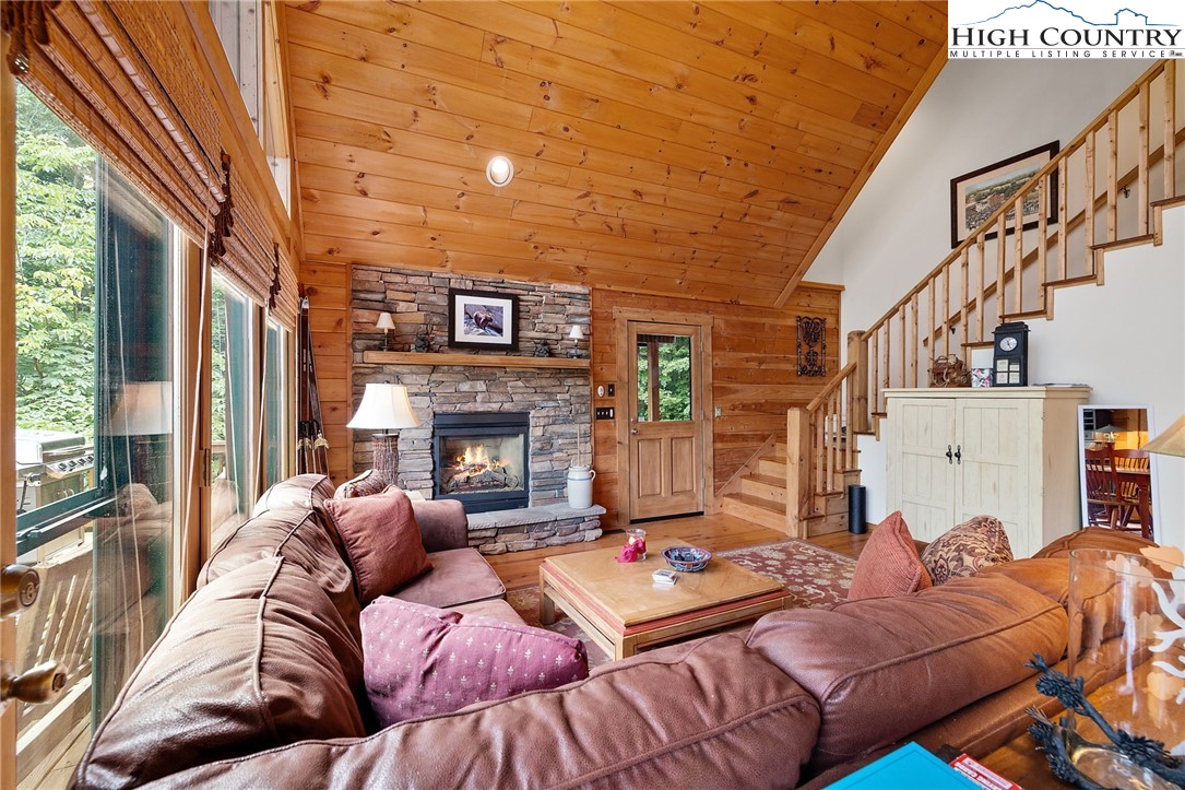 320 Timber Ridge Road Sugar Mountain, NC 28604 - Photo 19 of 30 a living room with furniture fireplace and a large window