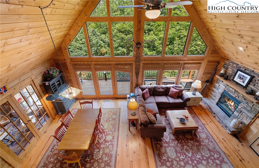 320 Timber Ridge Road Sugar Mountain, NC 28604 - Photo 21 of 30 a living room filled with furniture and a floor to ceiling window
