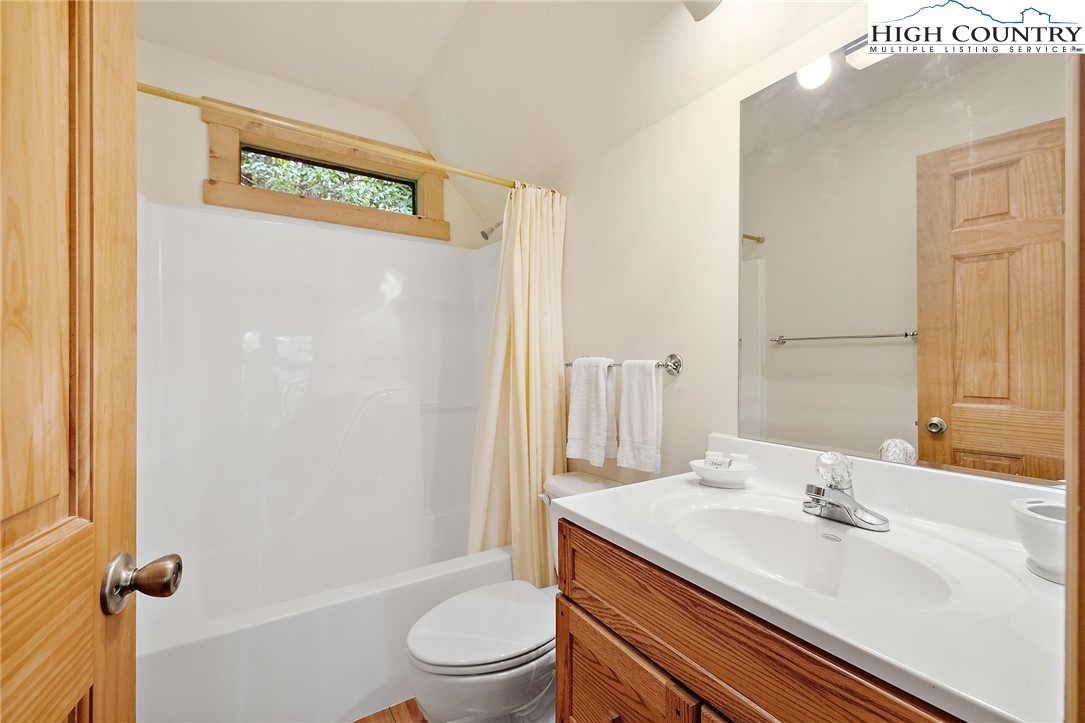 320 Timber Ridge Road Sugar Mountain, NC 28604 - Photo 23 of 30 a bathroom with a granite countertop sink toilet and shower
