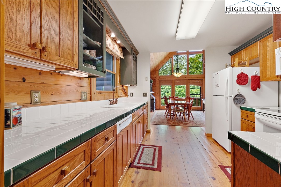 320 Timber Ridge Road Sugar Mountain, NC 28604 - Photo 27 of 30 a open kitchen with stainless steel appliances granite countertop a stove and wooden floor