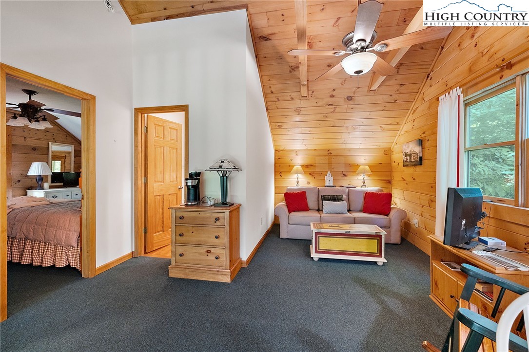 320 Timber Ridge Road Sugar Mountain, NC 28604 - Photo 30 of 30 a living room with furniture and a flat screen tv