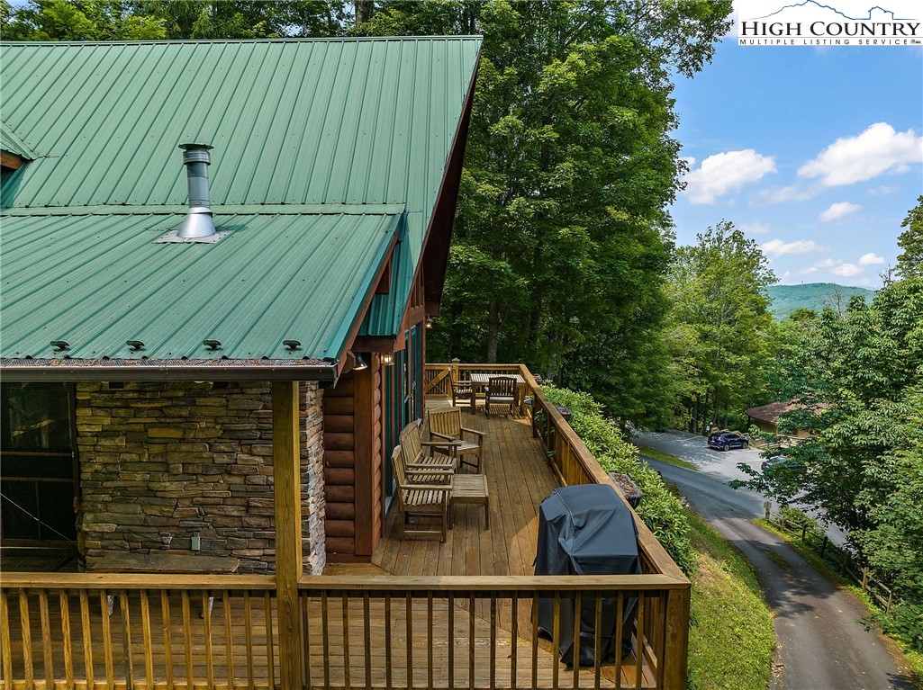 320 Timber Ridge Road Sugar Mountain, NC 28604 - Photo 5 of 30 a view of a balcony with wooden floor and fence