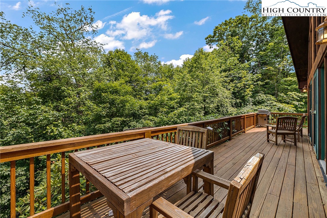 320 Timber Ridge Road Sugar Mountain, NC 28604 - Photo 9 of 30 a view of a balcony with wooden floor and outdoor seating