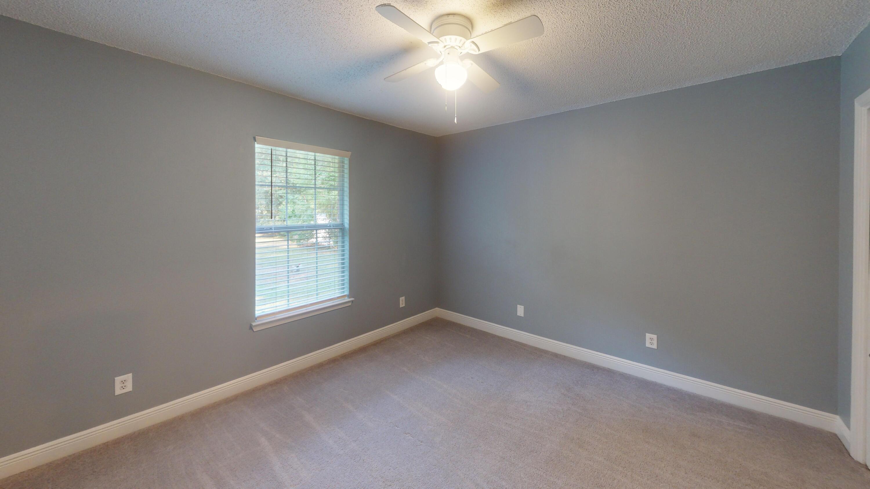 8118 Menorca Street Navarre, FL 32566 - Photo 12 of 14 an empty room with a window and a fan