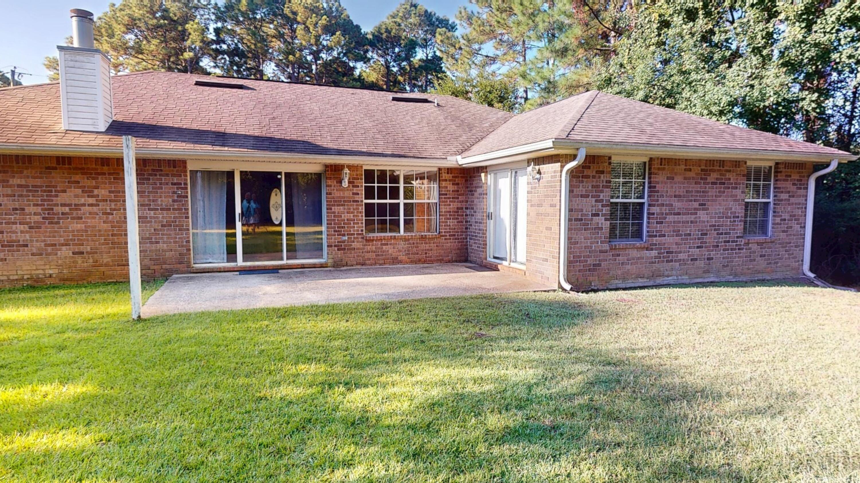 8118 Menorca Street Navarre, FL 32566 - Photo 13 of 14 a front view of a house with a yard